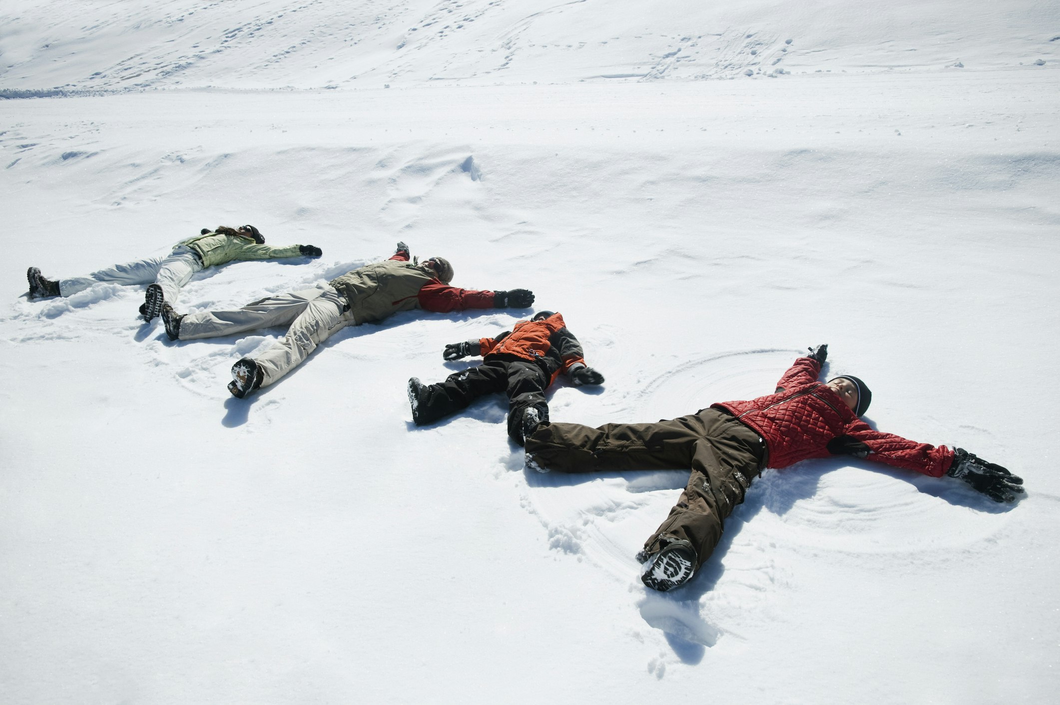 Family making snow angels